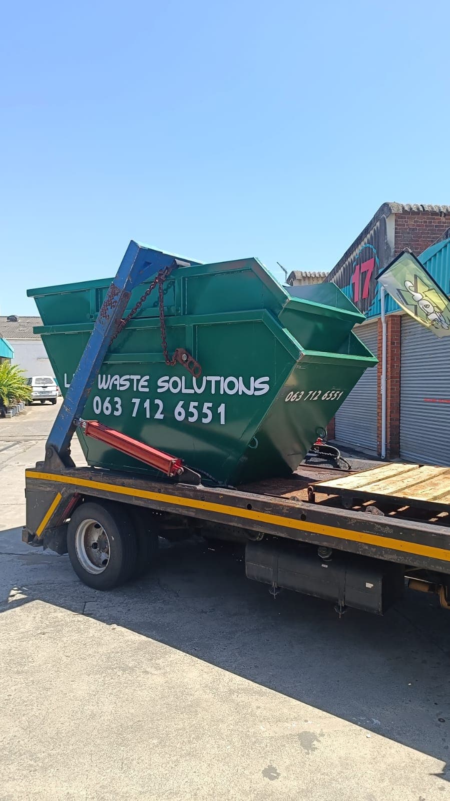 Loaded trailer with a full skip bin ready for collection